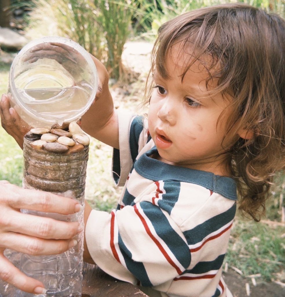 Children painting rocks they found during a child-led learning session at Firefly Forest School in Bangkok.