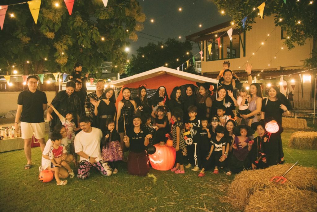 Families sharing a meal at Firefly Forest School’s halloween event in Bangkok.