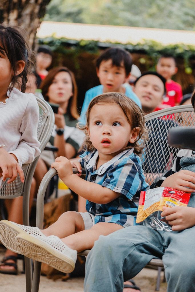 Toddlers exploring sensory play in the Secret Garden at Firefly Forest School’s Montessori-inspired school in Bangkok.

