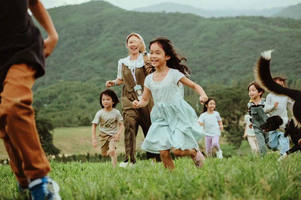 Children exploring nature during a playgroup session at Firefly Forest School in Thailand.

