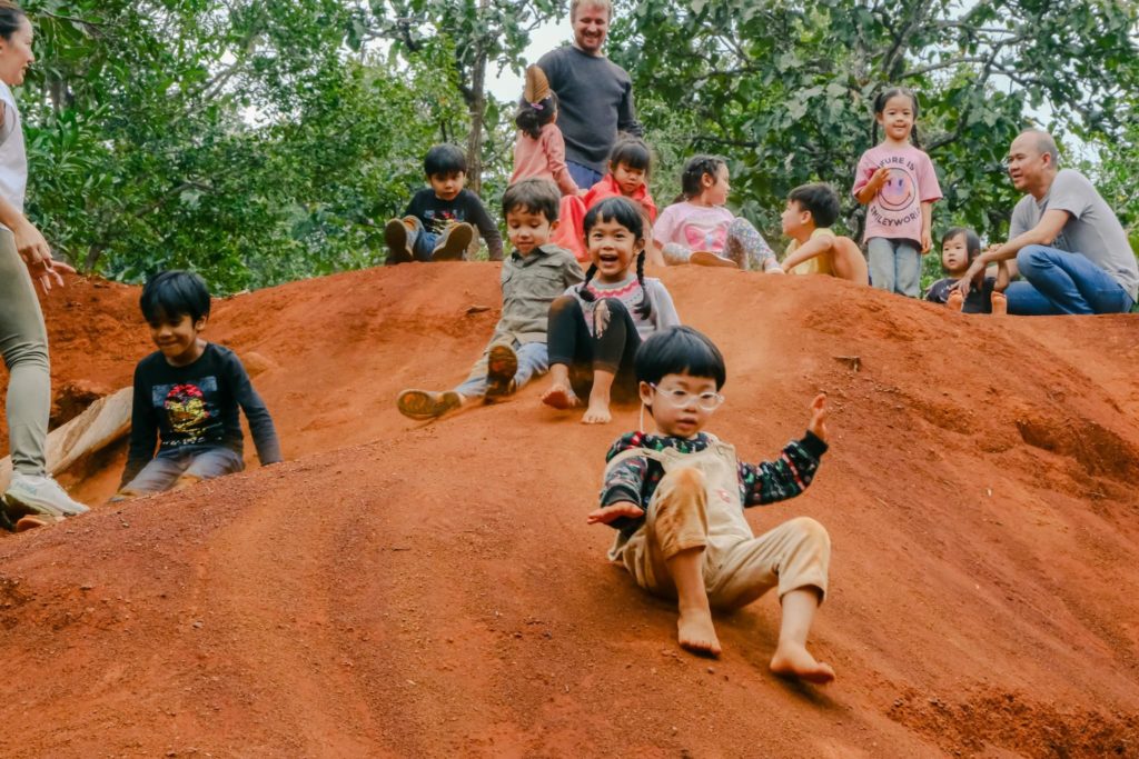 Expat children playing in the Secret Garden during a playgroup at Firefly Forest School in Bangkok.


