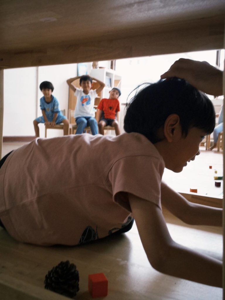 Children journaling about nature during a playgroup at Firefly Forest School in Bangkok.

